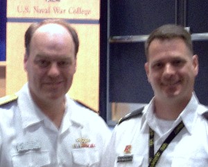 In June, Rear Adm. John Christenson, USN (l), president of the Naval War College, congratulates Lt. Col. Francisco DeCarvalho, USA, who received first prize in the Information Operations category during the chapter's writing contest.